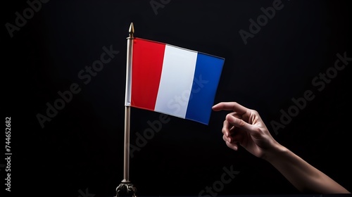 A person gently touching the national flag of france with love photo