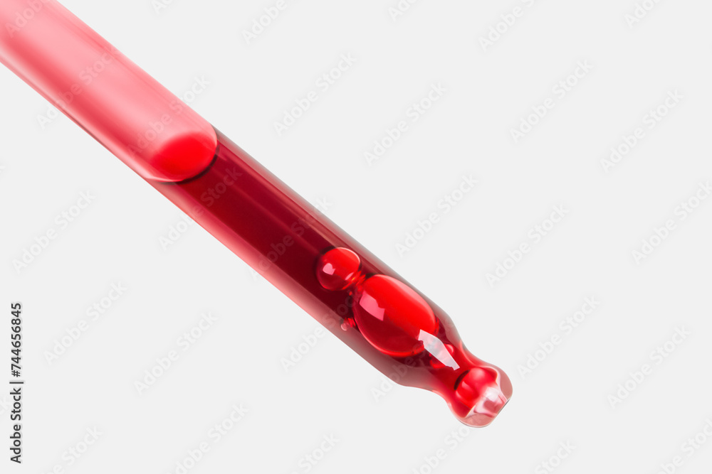 Red berry gel with acids in a pipette on a light background. Large picture. Red berry gel with acids in a pipette on a light background. Large picture.