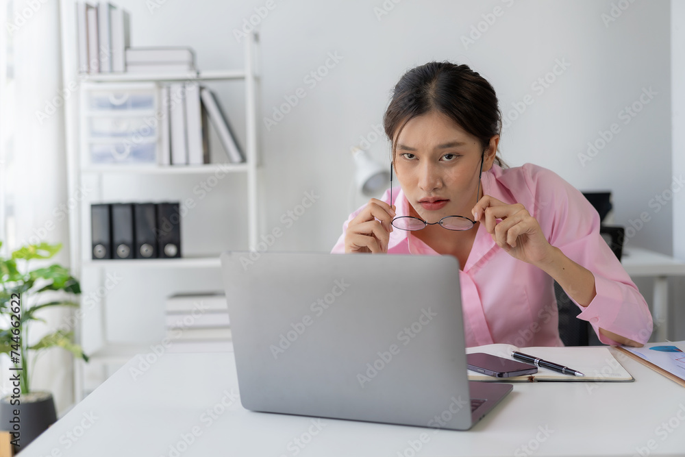 Annual summary report, laptop and paper placed at desk, Asian woman working online and planning financial data with laptop and succeeding with excited and happy face Annual summary report, laptop and paper placed at desk, Asian woman working online and planning financial data with laptop and succeeding with excited and happy face