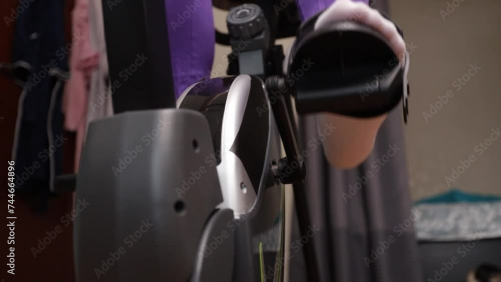 Exercise bike close-up, woman's legs in action, indoor cycling workout, health and fitness Exercise bike close-up, woman's legs in action, indoor cycling workout, health and fitness