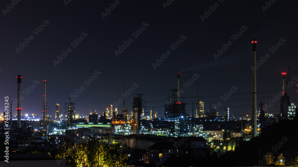 Night cityscape and oil refinery, petroleum oil yard, tank storage field. Crude oil, natural gas. Nice lighting cover the city. Business and industrail, import and export, international 