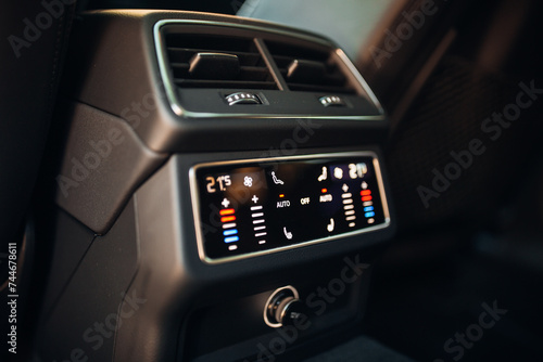 Car rear seats row air conditioning control. Cooling system modern adjustment screen in the expensive car © Moose