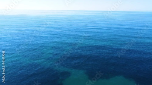 Aerial view of a blue sea under a blue sky photo