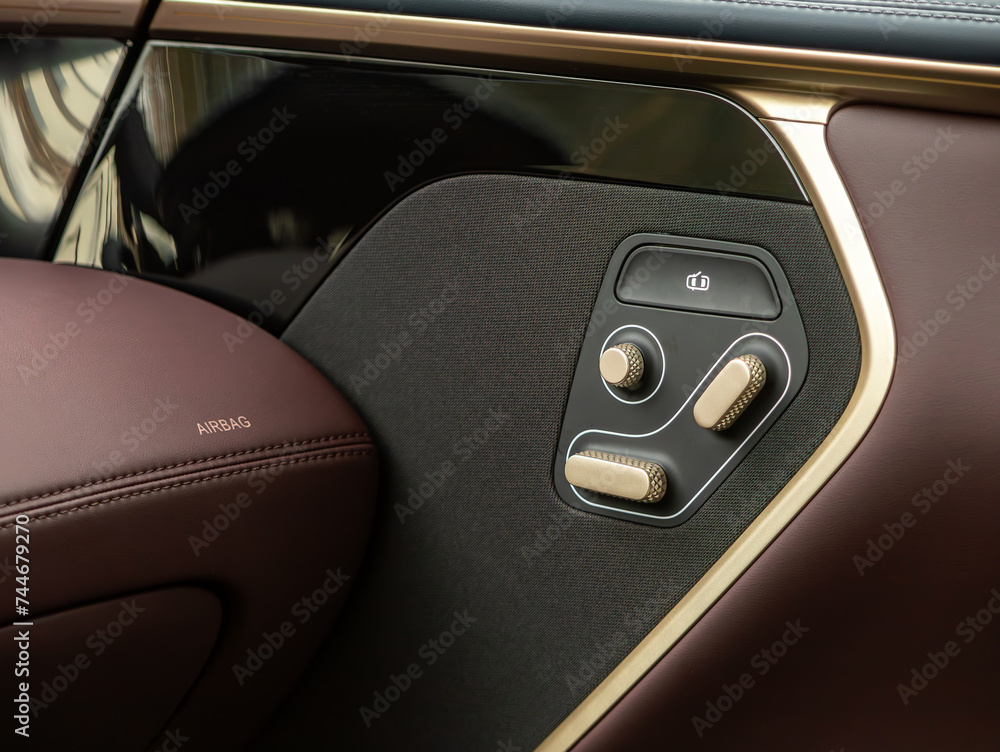 close-up  of seat setting buttons on car panel, no trade marks