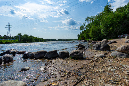 A fast river under a blue sky. photo