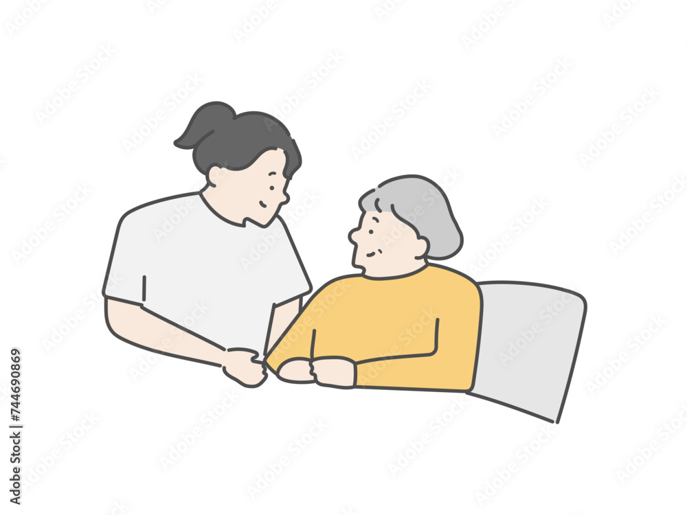 女性介護士とベッドにいる高齢女性