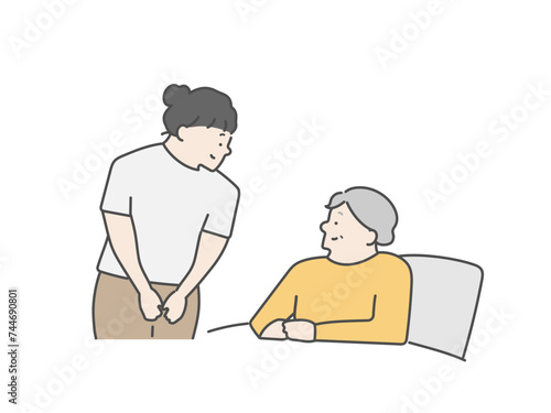 女性介護士とベッドにいる高齢女性