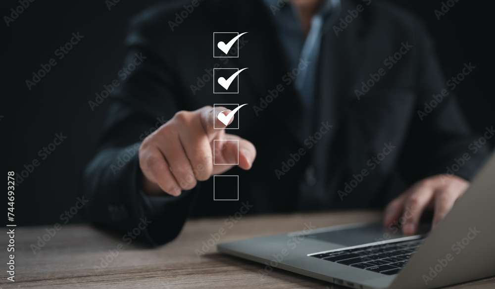 Performance checklist concept : businessman using finger with mobile phone for questionnaire, evaluation, assessment online or survey exam and filling out for digital survey and checklist