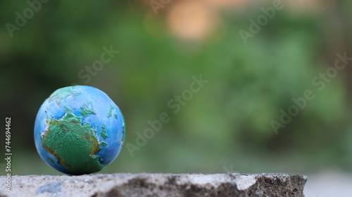 Environment Earth Day In the hands holding green earth on Bokeh green Background, Saving environment, and environmentally sustainable. Save Earth. Concept of the Environment World Earth Day © Worapon