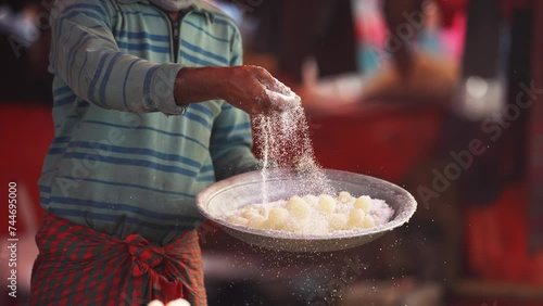 Art of making Rasgulla, a delightful Indian dessert made from milk solids, deep-fried to golden perfection and soaked in fragrant sugar syrup. Vibrant, aromatic, tempting. A feast for the senses photo