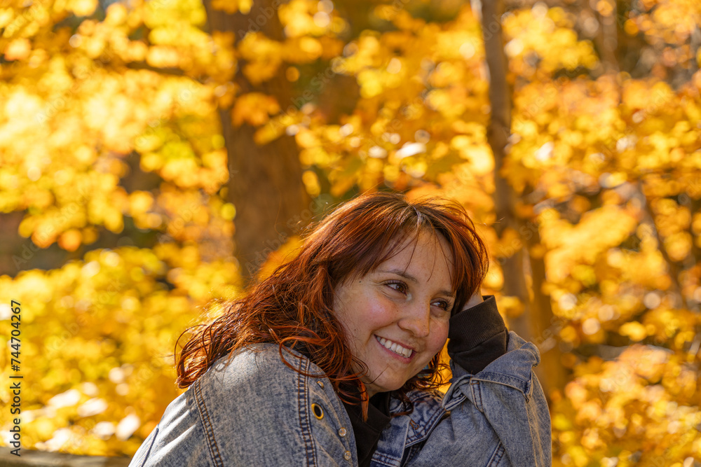 Portrait of a young girl smiling, with red hair and a fall landscape behind her Portrait of a young girl smiling, with red hair and a fall landscape behind her
