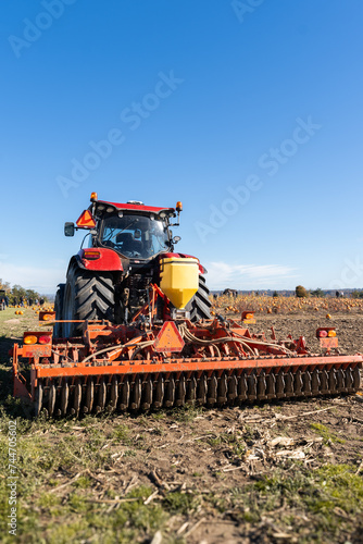 Red tractor working in a pumpkin crop