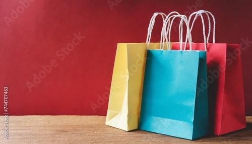 colorful paper shopping bag on red background for copy space retail shopping concept
