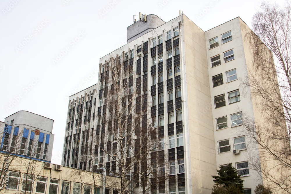 Windows of multi-storey tall building against background of sky