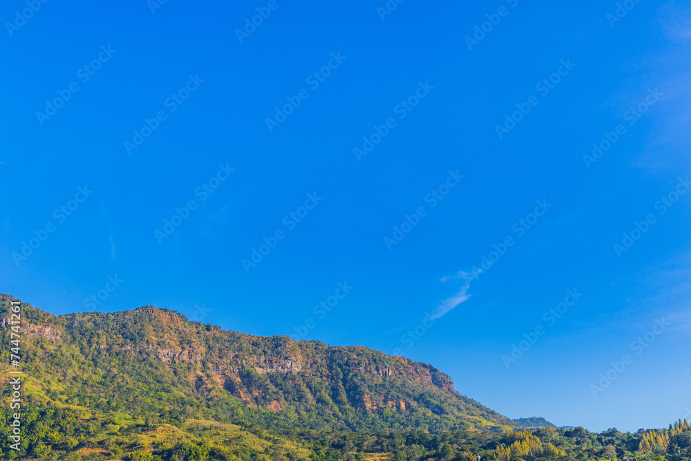 View of idyllic mountain scenery landscape in fine weather under blue sky View of idyllic mountain scenery landscape in fine weather under blue sky