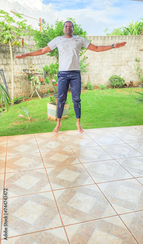 Man practicing calisthenics exercises at home