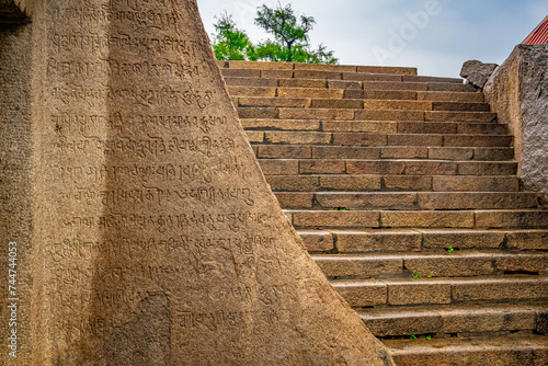 An Ancient Tamil Letters Inscription or Vattezhuthu or grantha script at near Tiger Cave is a rock-cut Hindu temple, Rockcut Shiva Temple (Excavated) located in the hamlet of near Mahabalipuram. photo