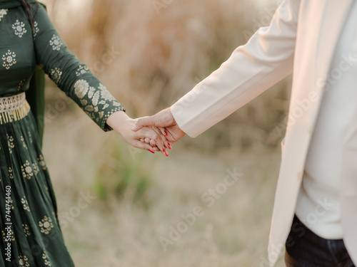 bride and groom holding hands