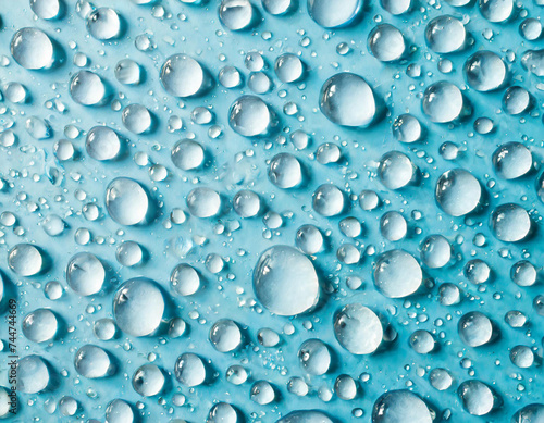 Wallpaper Mural A top view closeup of multiple water drops on a light blue background Torontodigital.ca