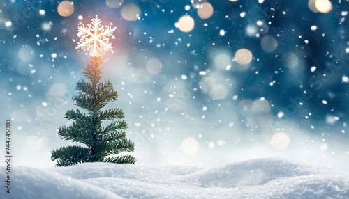 abstract winter background featuring a blurred christmas tree in a snowy landscape with a snowflake as a symbol of christmas photo