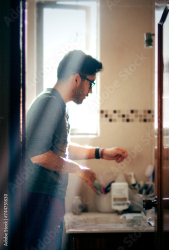Latin American male using bathroom's sink