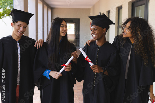 Diverse students celebrate graduation at high school photo