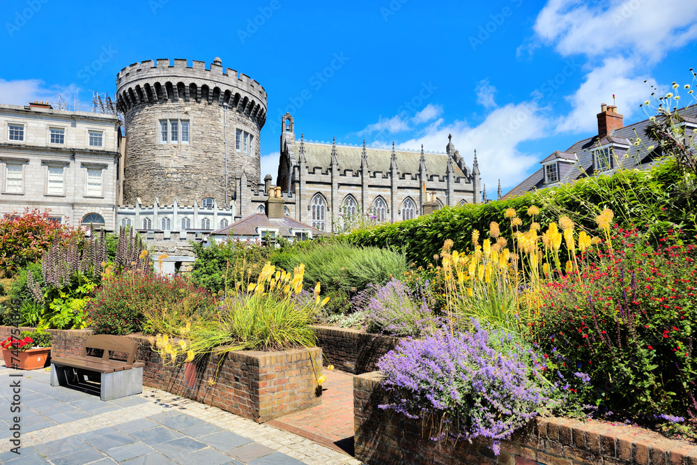 Fototapeta premium Dublin Castle with colorful flowers seen from Dubh Linn gardens, Ireland
