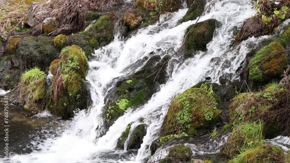 Crystal clear ice water falling between stones in the river Crystal clear ice water falling between stones in the river