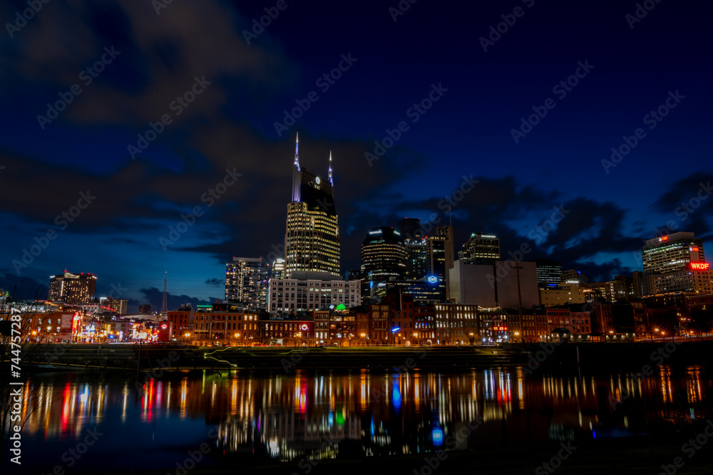 Naklejka premium Aerial panoramic of Nashville Skyline at Sunset by Cumberland River