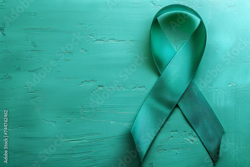 Teal Awareness Ribbon on Textured Jade Background, Copy Space