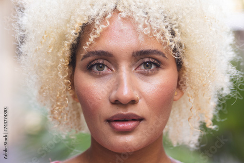 Close-up of a young biracial woman outdoors photo