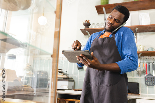 African American man taking inventory in a cafe, with copy space