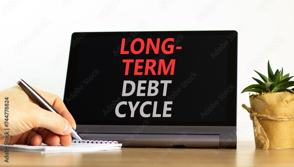 Long-term debt cycle symbol. Concept words Long-term debt cycle on beautiful black tablet. Beautiful white background. Businessman hand. Calculator. Business Long-term debt cycle concept. Copy space. Long-term debt cycle symbol. Concept words Long-term debt cycle on beautiful black tablet. Beautiful white background. Businessman hand. Calculator. Business Long-term debt cycle concept. Copy space.