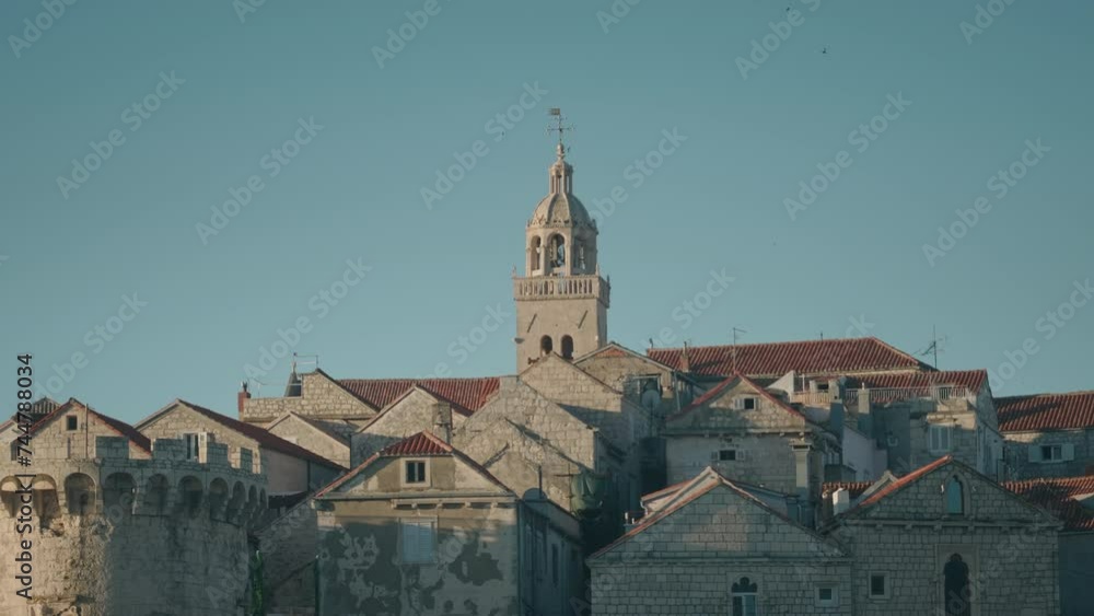 Close-up shot of mediterranean town with traditional architecture. Bell tower and stone fasade. Clear blue sky. Close-up shot of mediterranean town with traditional architecture. Bell tower and stone fasade. Clear blue sky.