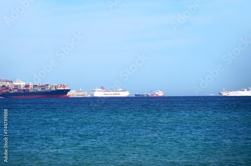 Fully loaded container ship and cruise ship, ferry and other ships in the Bay of Gibraltar, logistic, Gibraltar, Rock of Gibraltar, sea freight, economy
