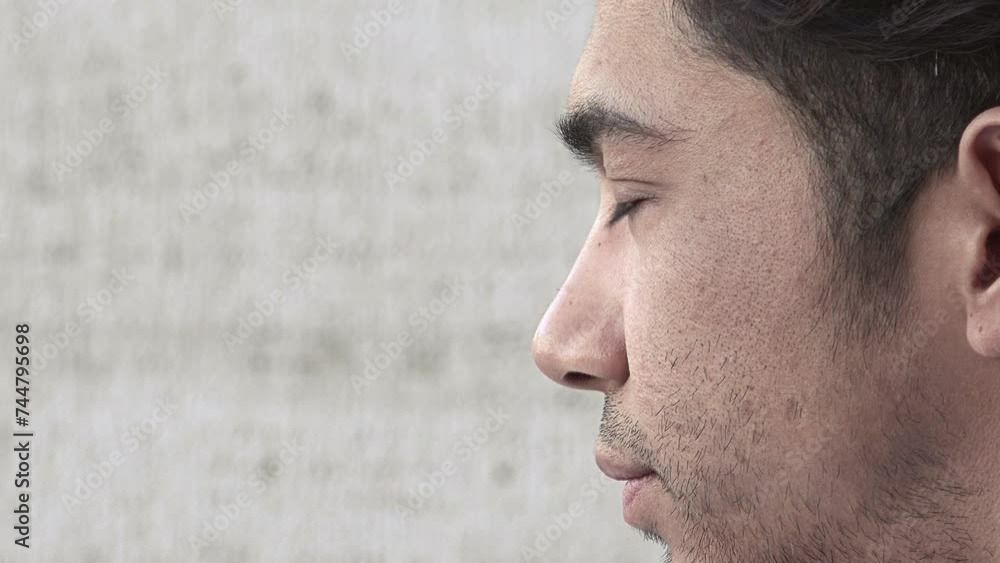 pensive young man looking around him: side closeup portrait pensive young man looking around him: side closeup portrait