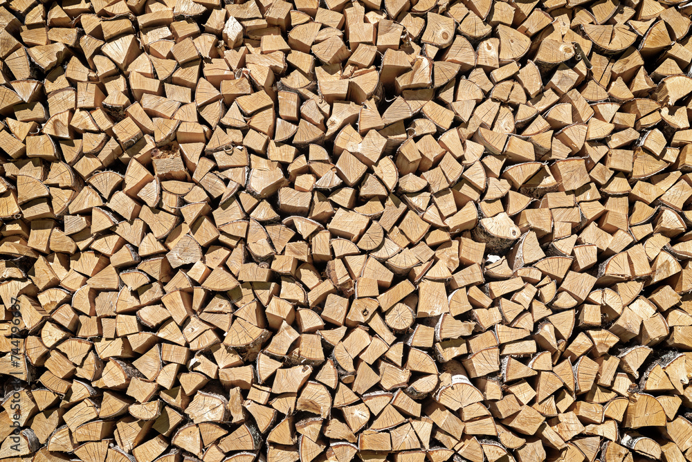 Birch firewood stacked in a woodpile, background. Birch firewood stacked in a woodpile, background.
