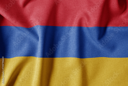 National Flag on Textured Fabric Background. Silk textured flag, realistic wave and flag look. AM Flag of Armenia