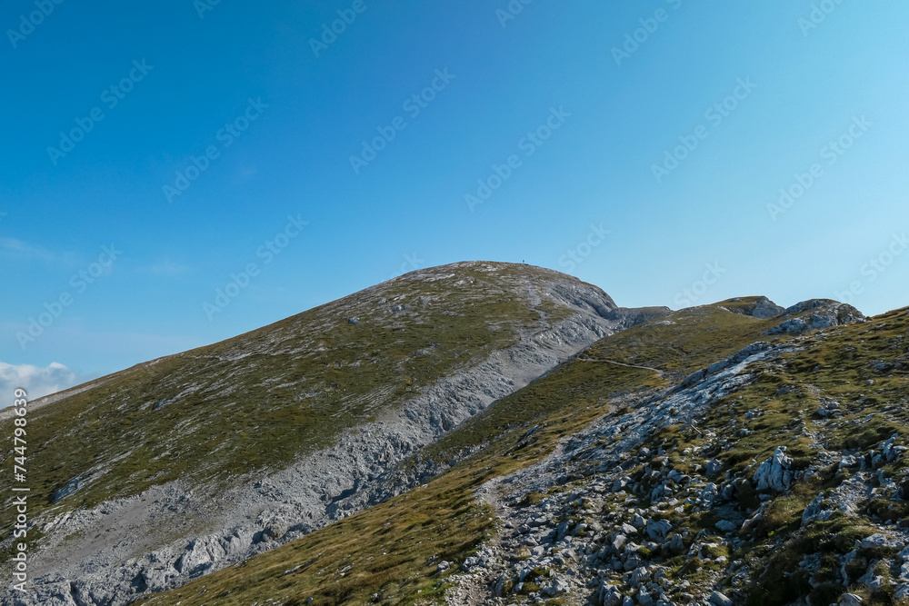 Panoramic view of majestic mountain peak of Hochschwab massif, Styria, Austria. Idyllic hiking trail on high altitude alpine meadow, remote Austrian Alps in summer. Seen from top of mount Zagelkogel