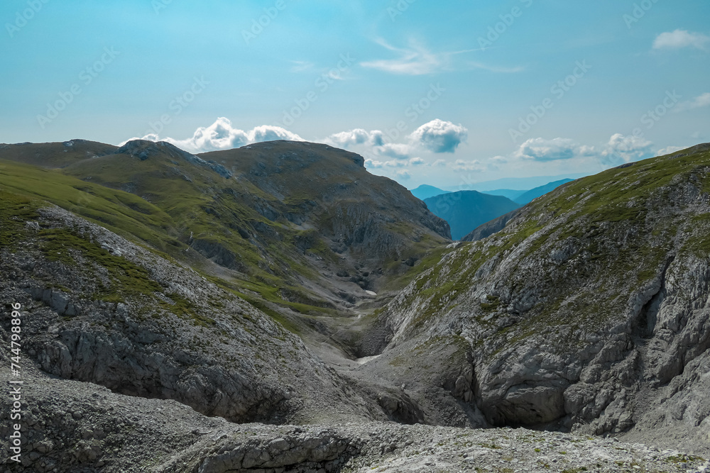 Fototapeta premium Panoramic view of majestic mountain peaks of Hochschwab massif, Styria, Austria. Idyllic hiking trail on high altitude alpine terrain, remote Austrian Alps in summer. Sense of escape. Nature lover