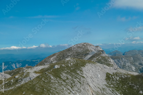 Panoramic view of majestic mountain peak of Hochschwab massif, Styria, Austria. Idyllic hiking trail on high altitude alpine meadow, remote Austrian Alps in summer. Seen from top of mount Zagelkogel photo