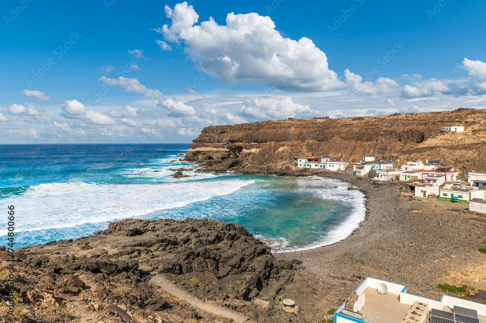 Explore the secluded charm of Los Molinos, Fuerteventura, where rugged cliffs and azure waves create a tranquil, untouched coastal haven.