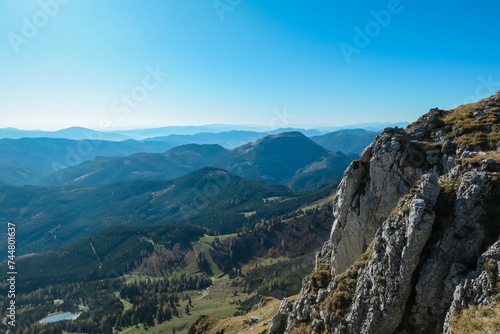 Panoramic view from top of mountain peak Hohe Veitsch in Mürzsteg Alps, Styria, Austria. Idyllic hiking trail in alpine terrain. Wanderlust remote Austrian Alps in autumn. Steep cliff rock formation