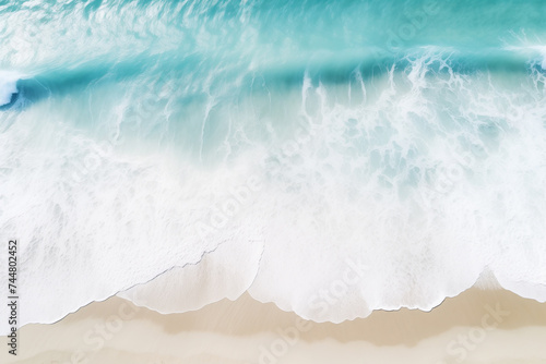 Aerial view of white sandy beach and water surface texture, foamy waves