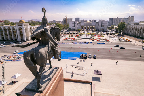Aerial top view to Monument Epic Statue of Aykol Manas - kyrgyz hero on Ala-Too Square. State History Museum in downtown of Bishkek city. Central asia, Kyrgyzstan. photo