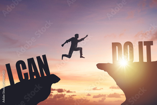 Silhouette of a man jumping from cliff to cliff, business and success concept