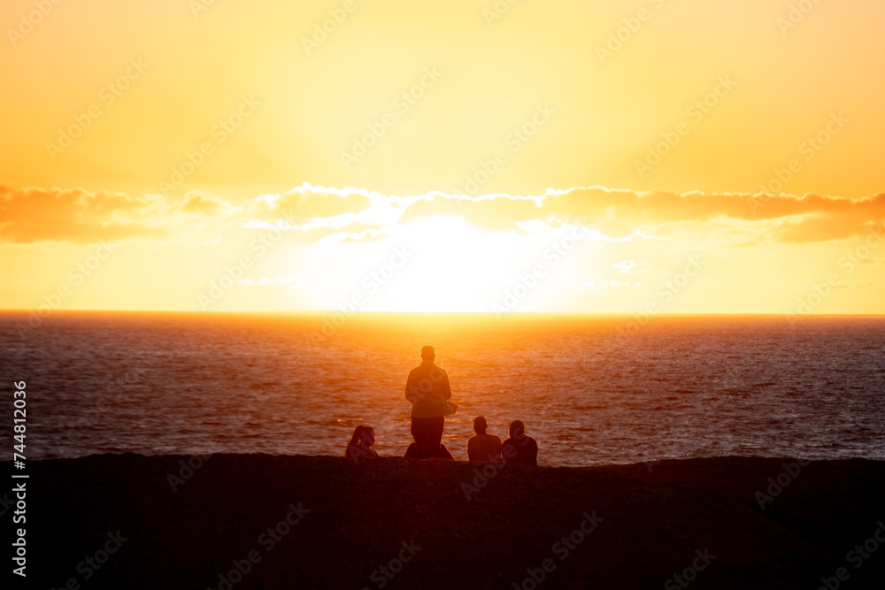 Friends on the beach at sunset in Cape Town, South Africa