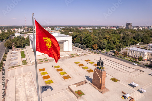 Aerial top view to Flag Kyrgyzstan. Monument Epic Statue of Aykol Manas - kyrgyz hero on Ala-Too Square. State History Museum in downtown of Bishkek city. Central asia, photo