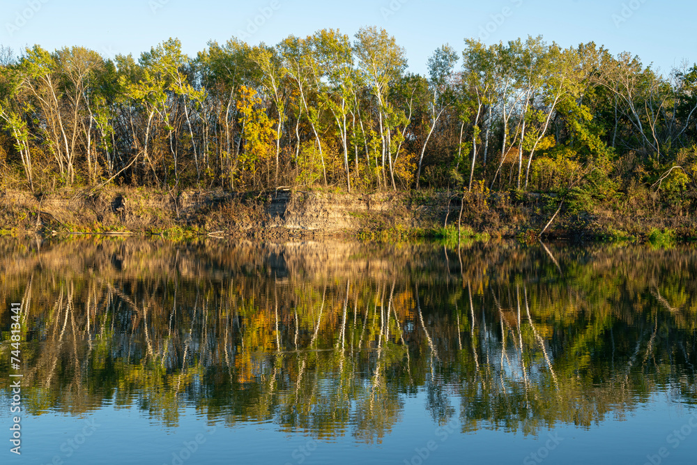reflection of autumn trees in the water