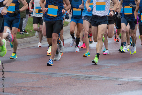 Young strong men running marathon 